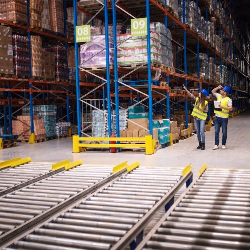 warehouse-workers-checking-inventory-goods-distribution-large-storehouse_342744-1482