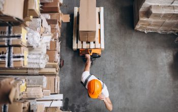 young-man-working-warehouse-with-boxes_1303-16617