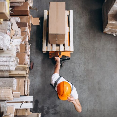 young-man-working-warehouse-with-boxes_1303-16617